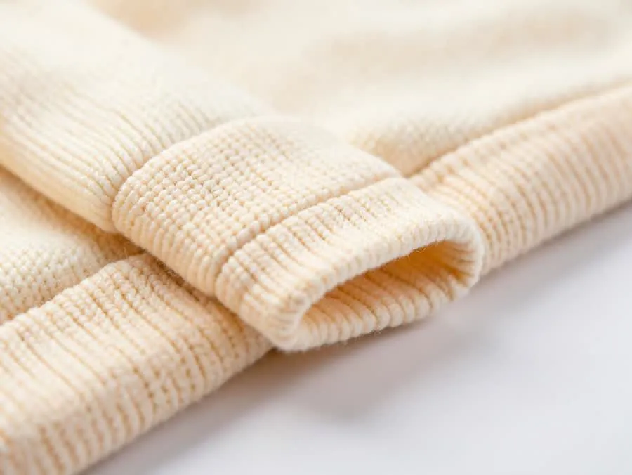 Close-up of premium Turkish french terry hoodie fabric in cream, 100% cotton, used for team hoodies